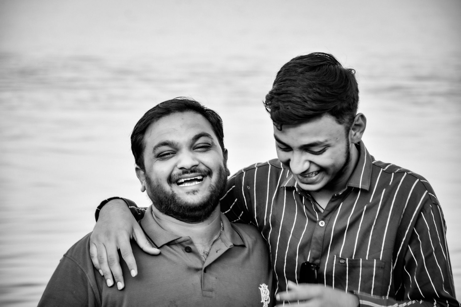two friends standing and laughing Candid photography tips and examples